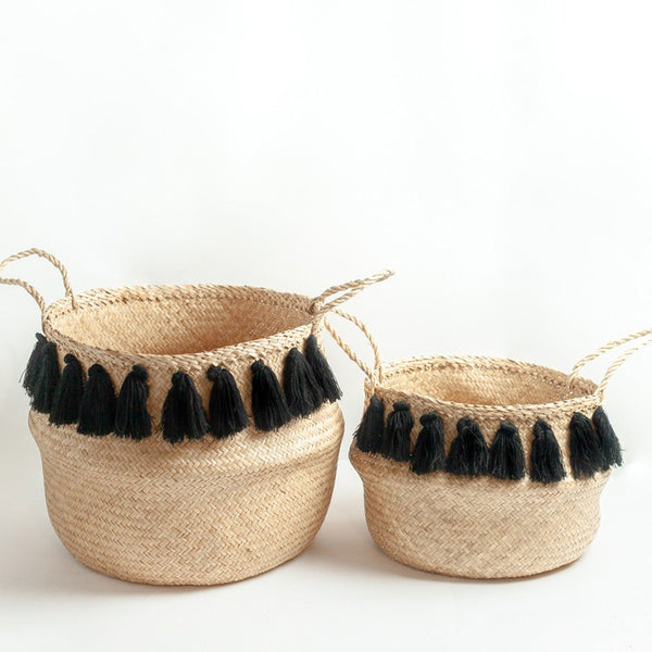 Set of woven baskets with black tassels on white background