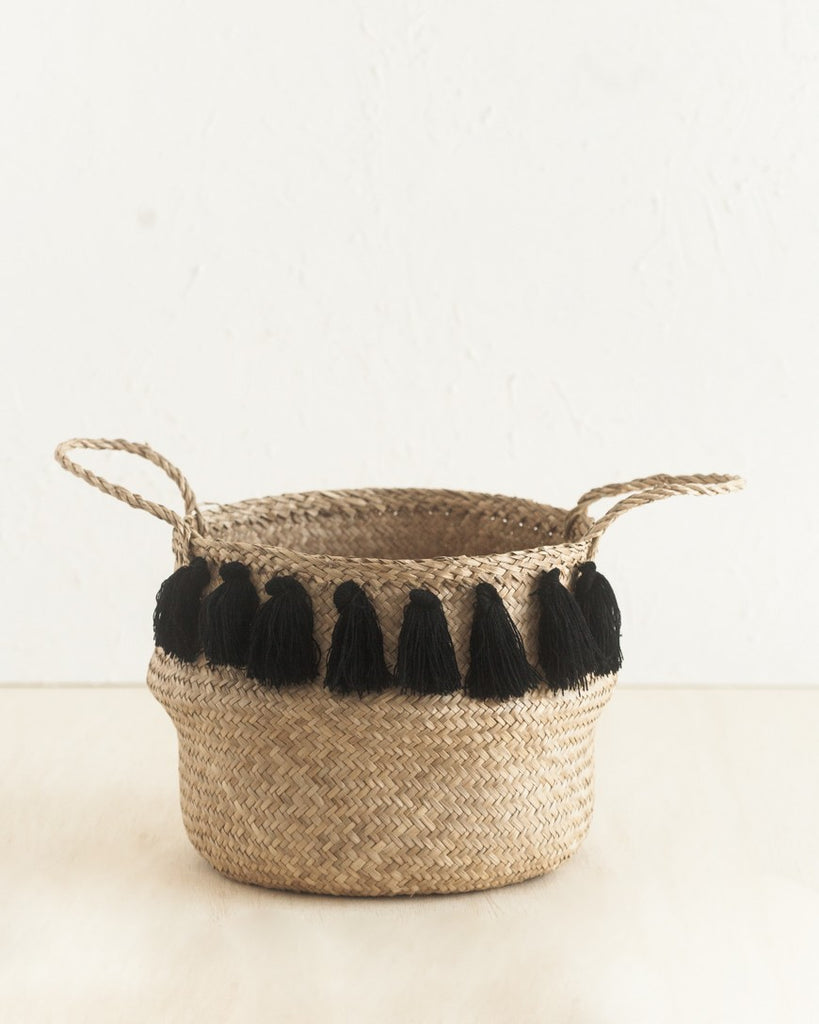 Single basket with black tassels on tan background