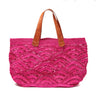 Pink colored crocheted open weave carryall with leather handles