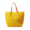 Sunflower colored crocheted carryall with snap closure, cotton lining & leather straps