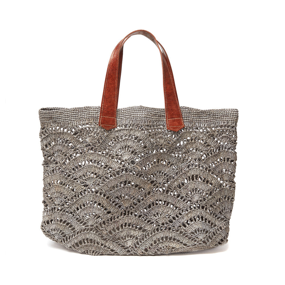 Dove colored crocheted open weave carryall with leather handles