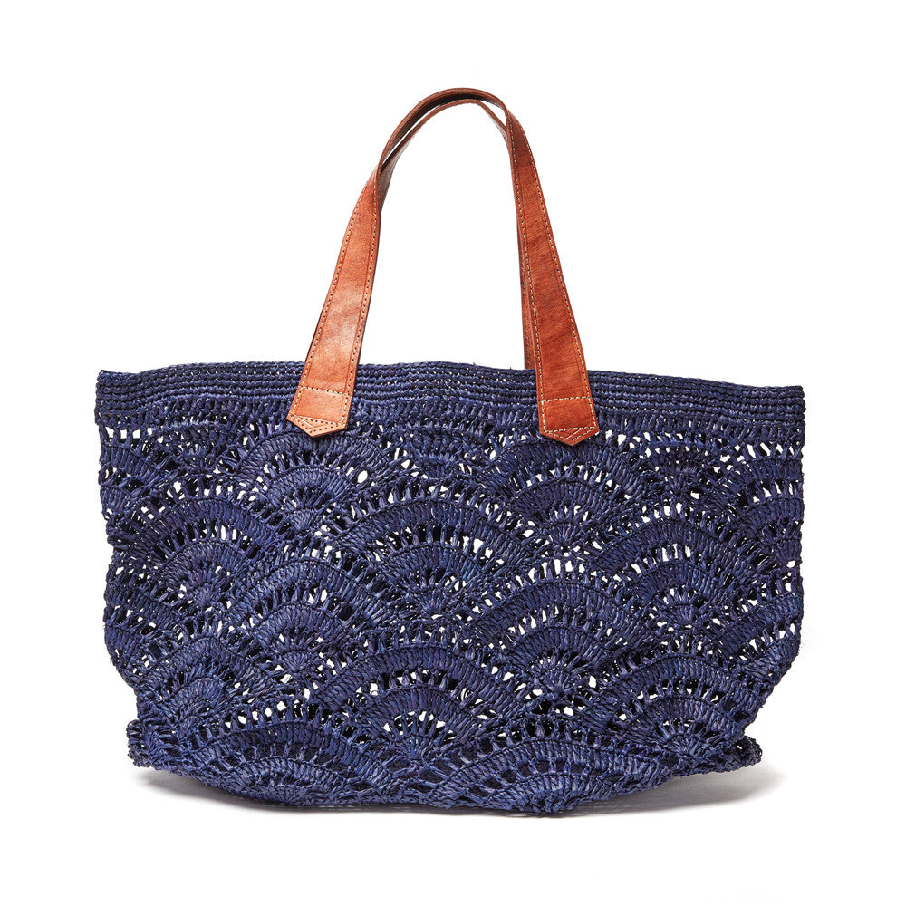 Navy colored crocheted open weave carryall with leather handles
