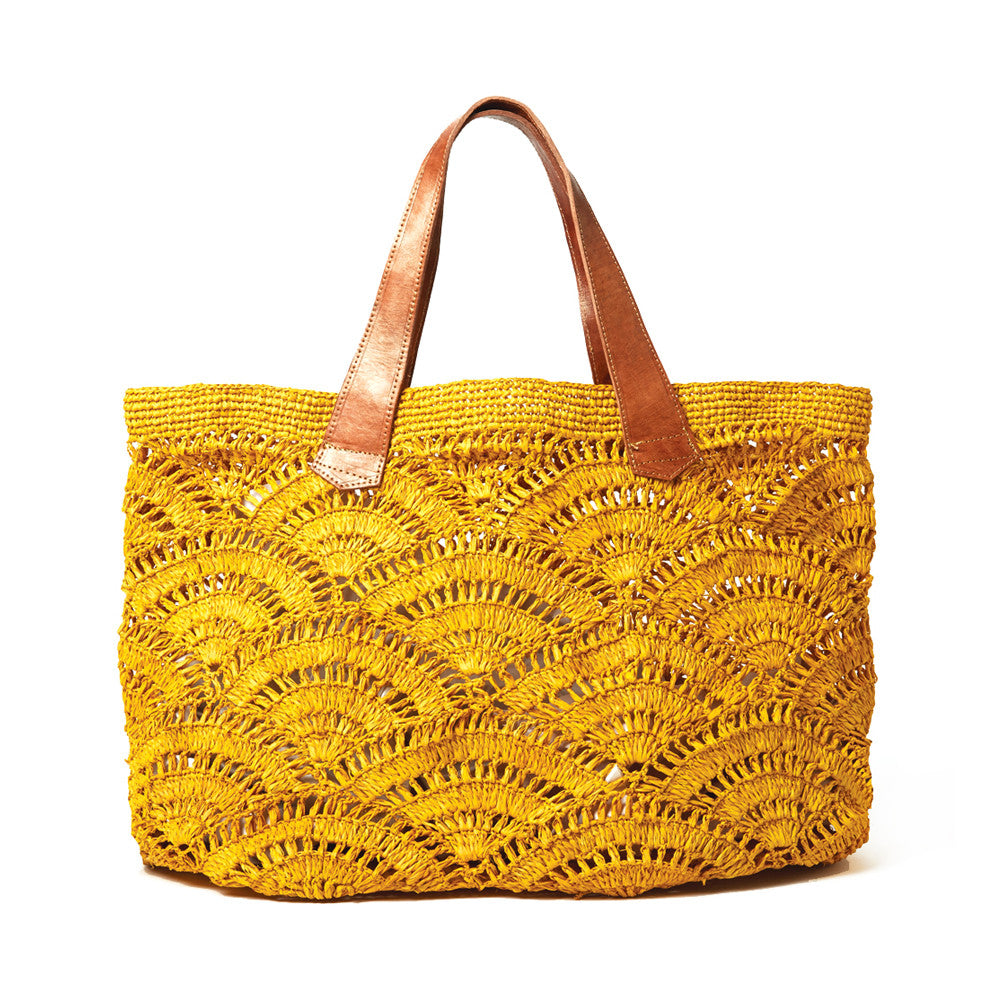 Sunflower colored crocheted open weave carryall with leather handles